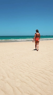 Direct beach access with soft sand and clear water—perfect for relaxing walks.