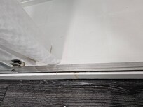 Empty track of missing sliding shower door