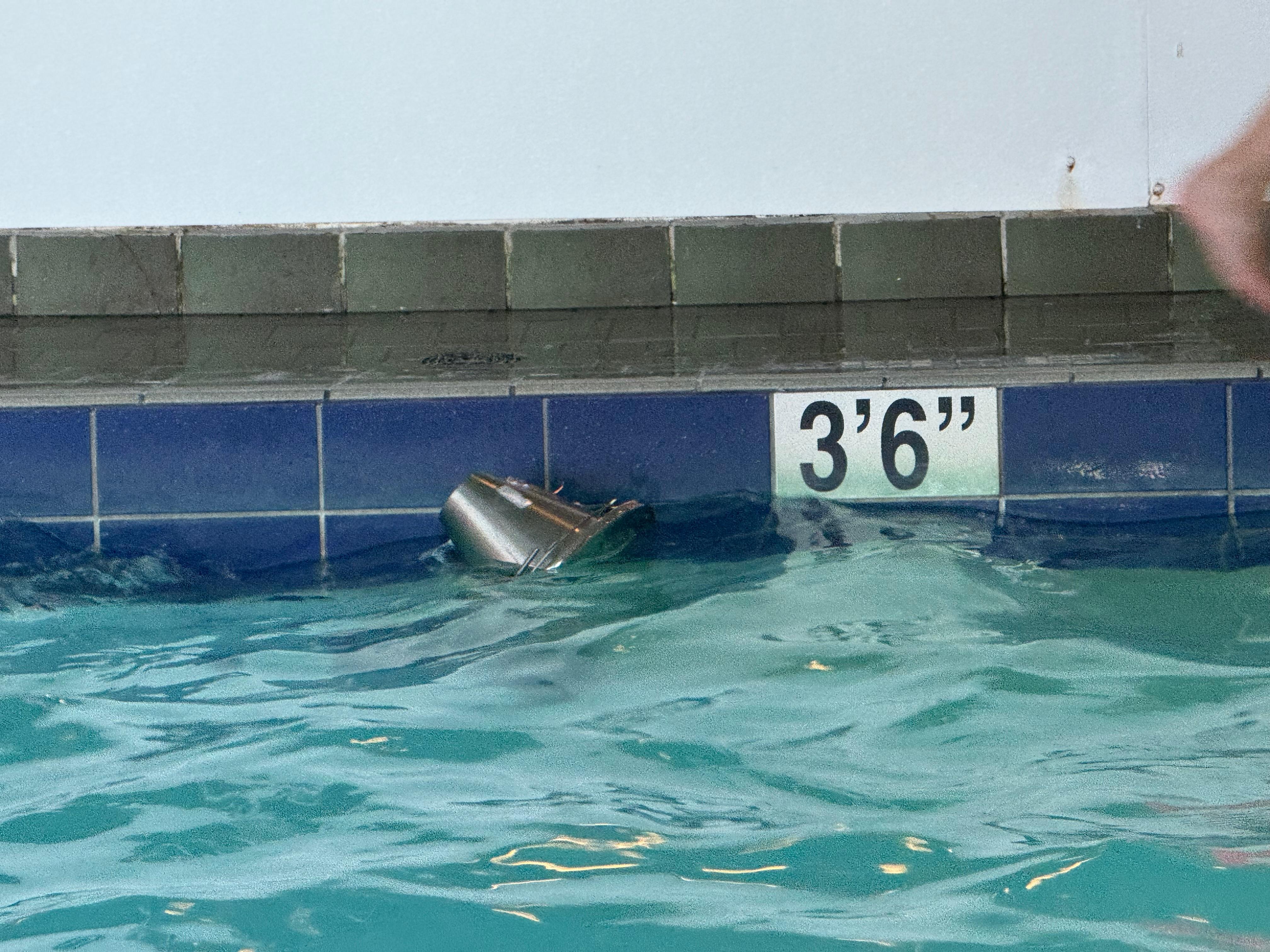 The pool area needs updating. That’s the pool light floating in the water.