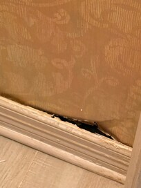 Master bathroom floor with enlarge hole in wall.