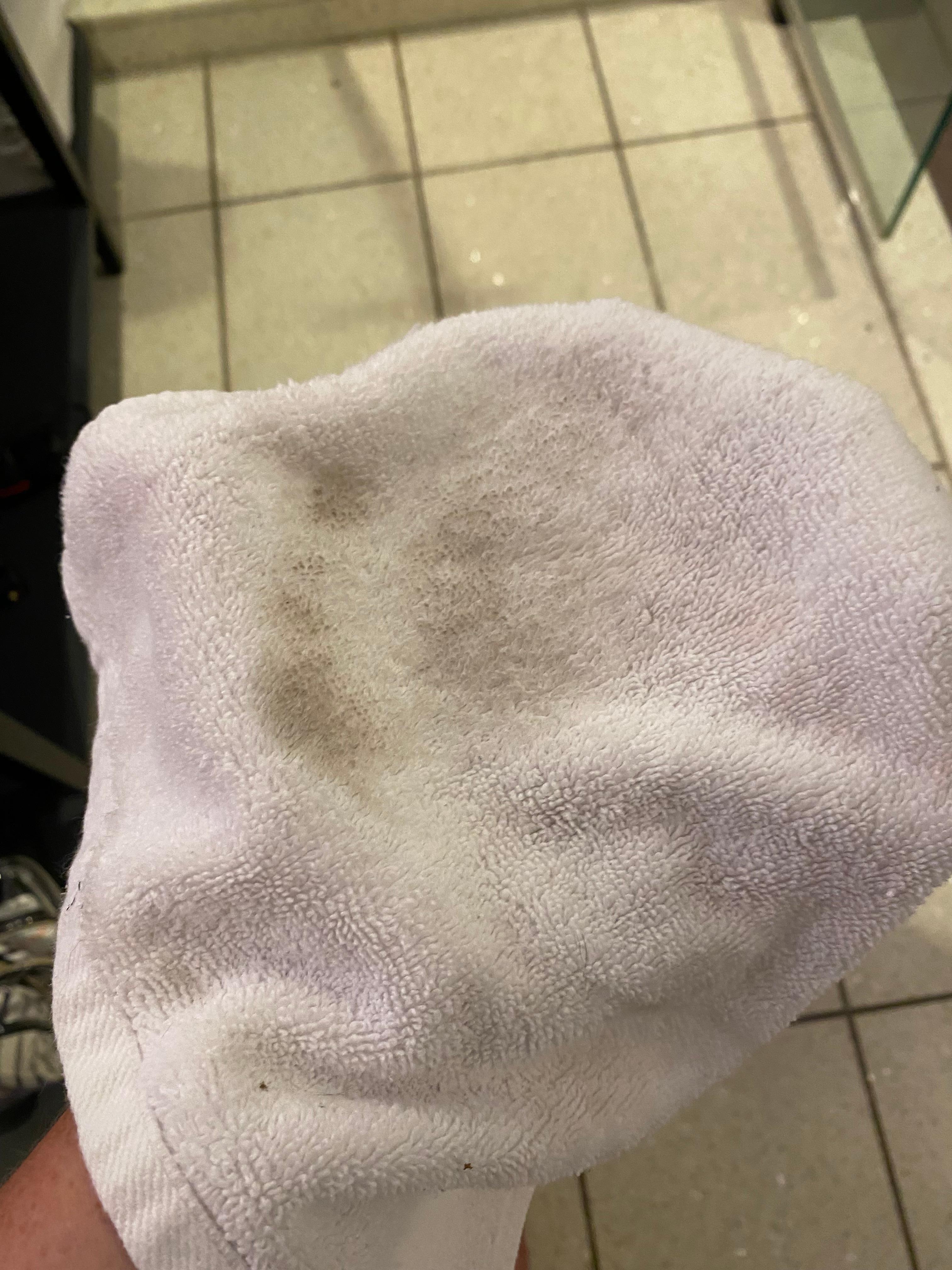 Wiping wet rag on the room floor.