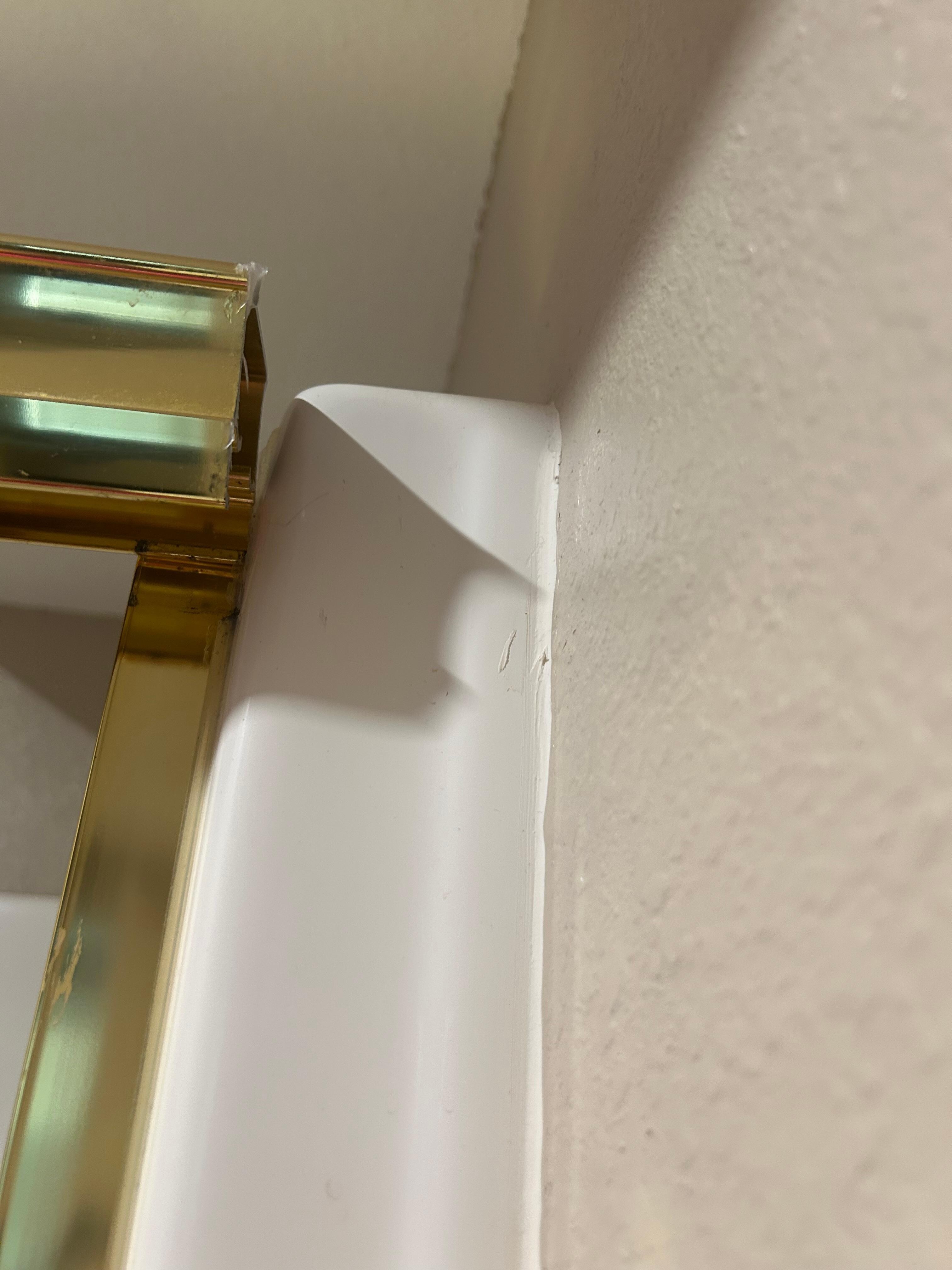 The top rail to hold the shower doors in place in room bathroom, unable to shut the doors 