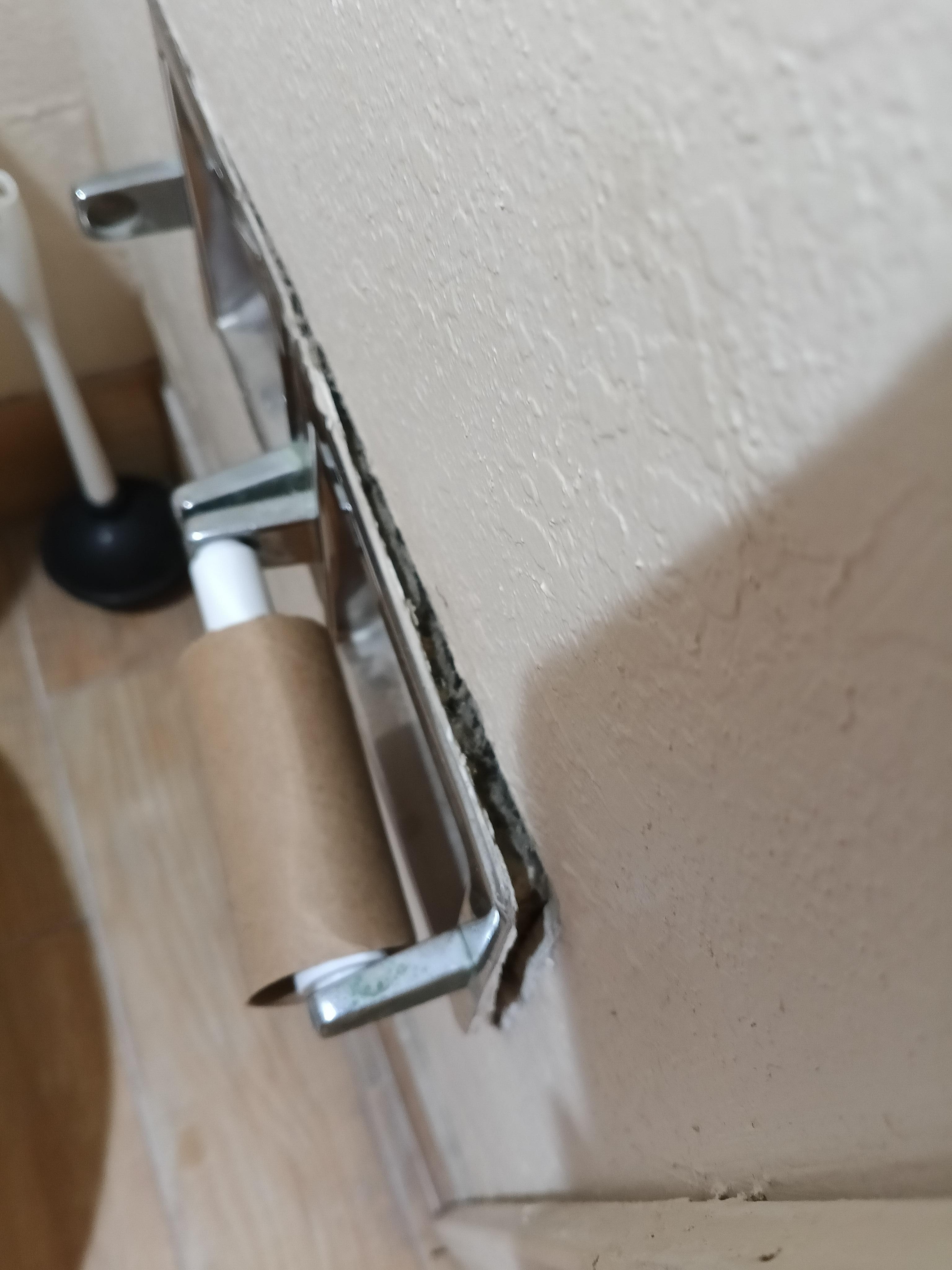 Only a small portion of paper and the holder coming out of the wall