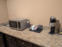 There's a mini fridge, coffee maker with coffee and tea pods (we used them all)