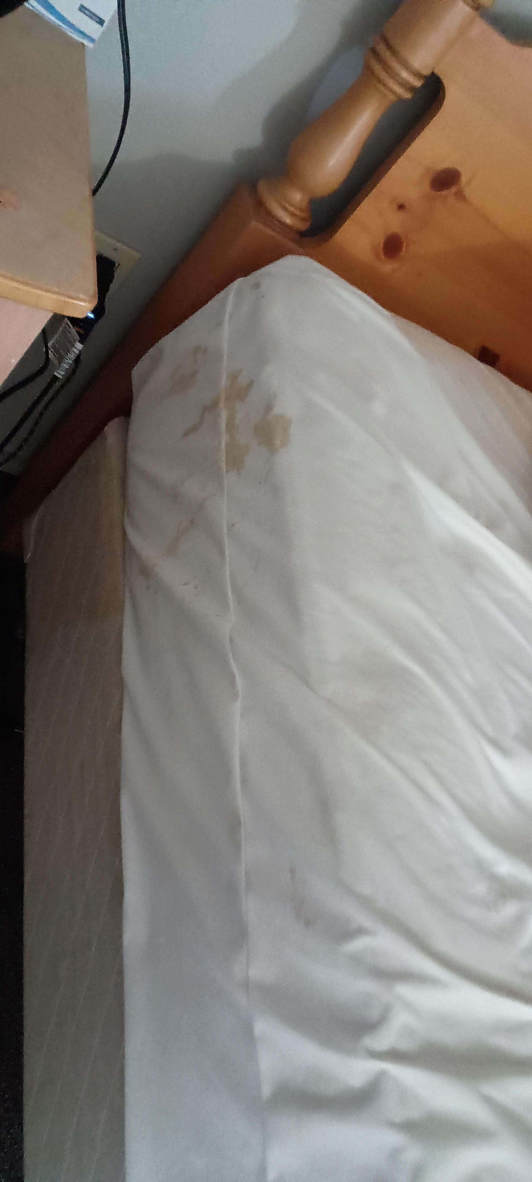 Stained. Dirty sheets from previous guests