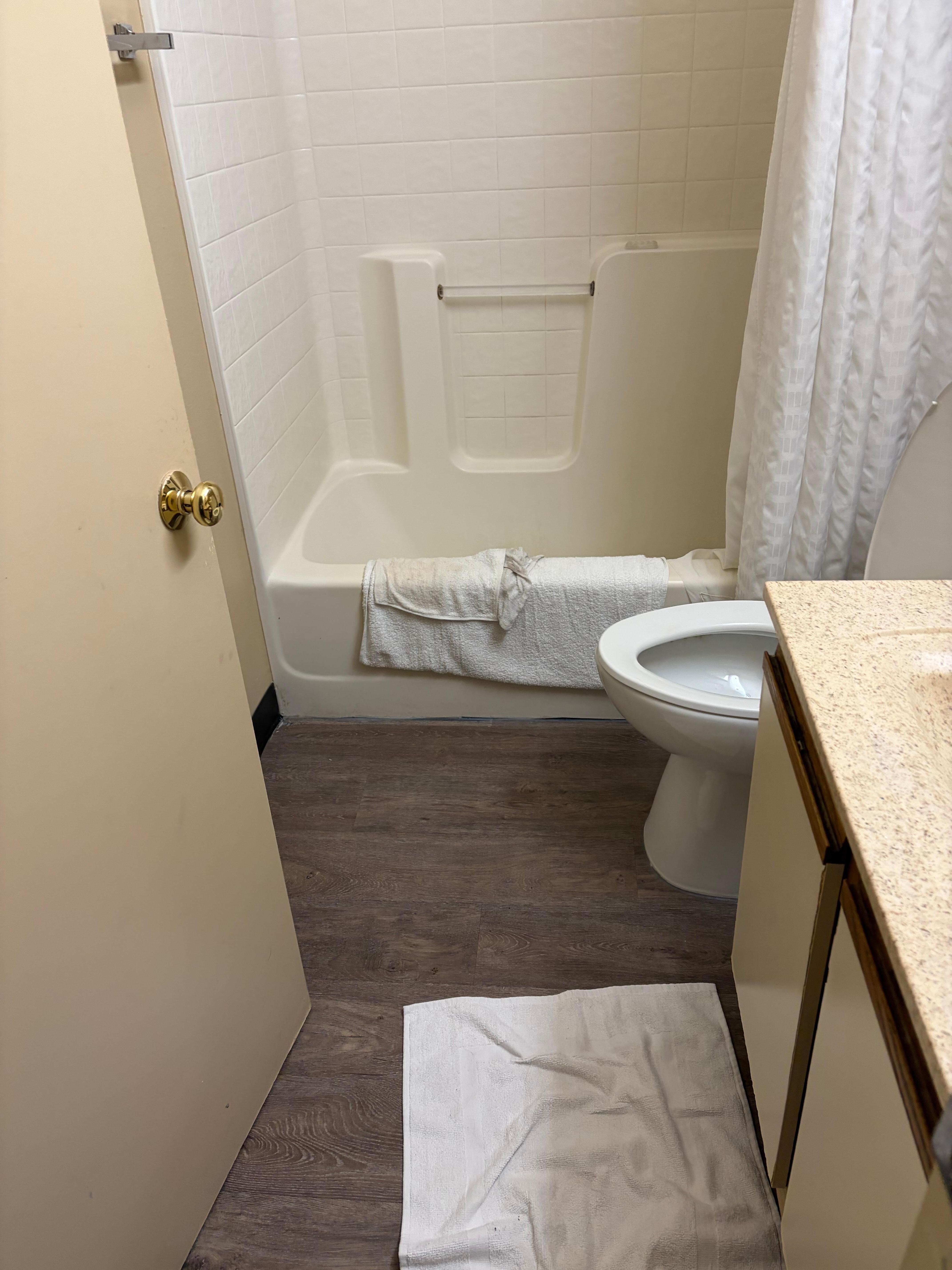 See washcloth on tub from cleaning the floor.