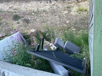 Abandoned furniture outside the hotel.