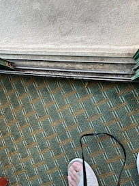 Stuff in track of balcony sliding door-hard to open and impossible to lock