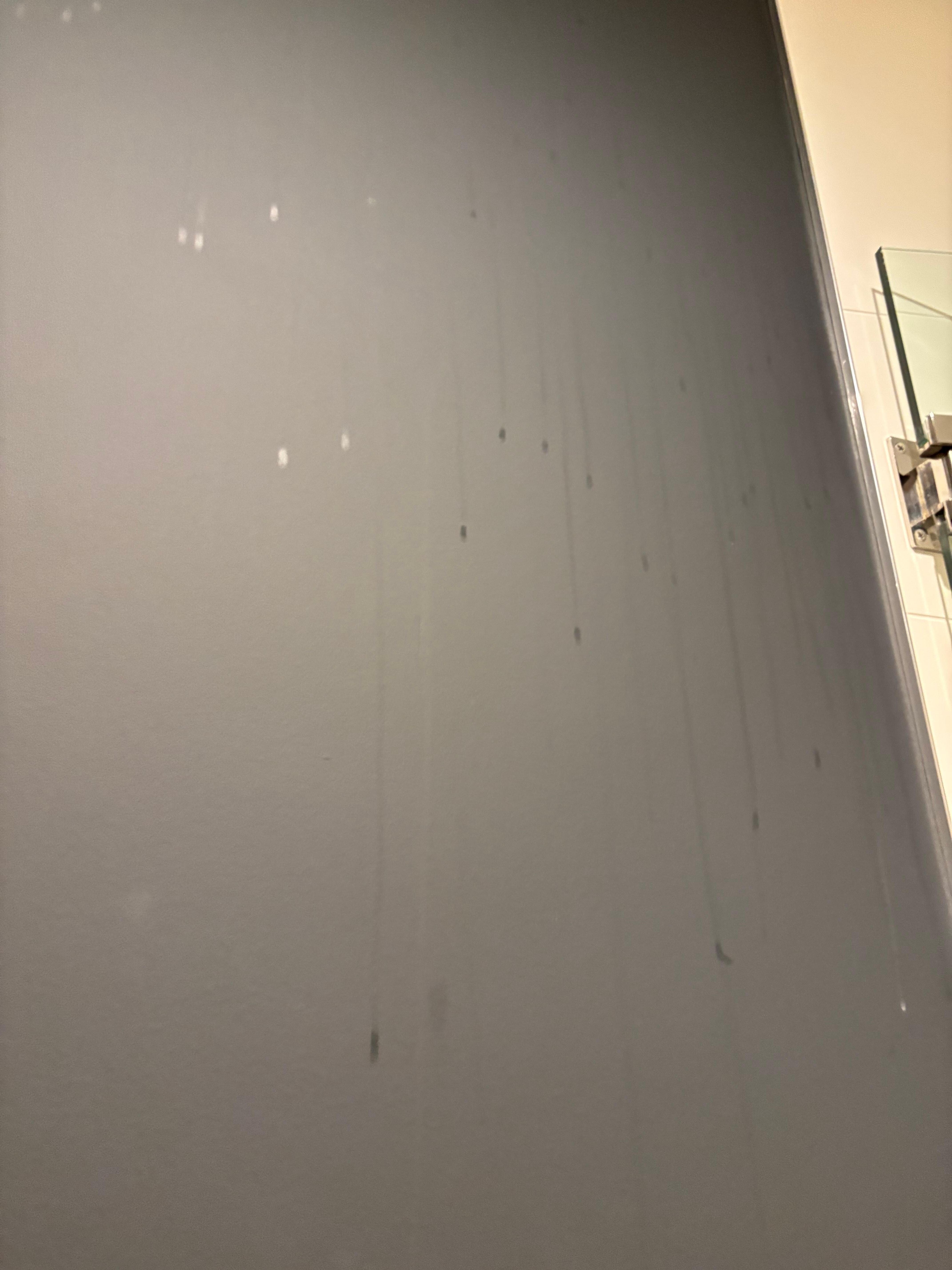 Coffee streaks spilled on wall not cleaned 