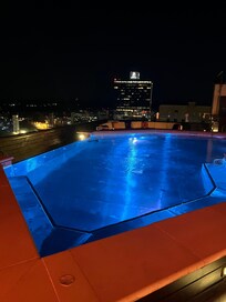 Rooftop pool & skyline at night