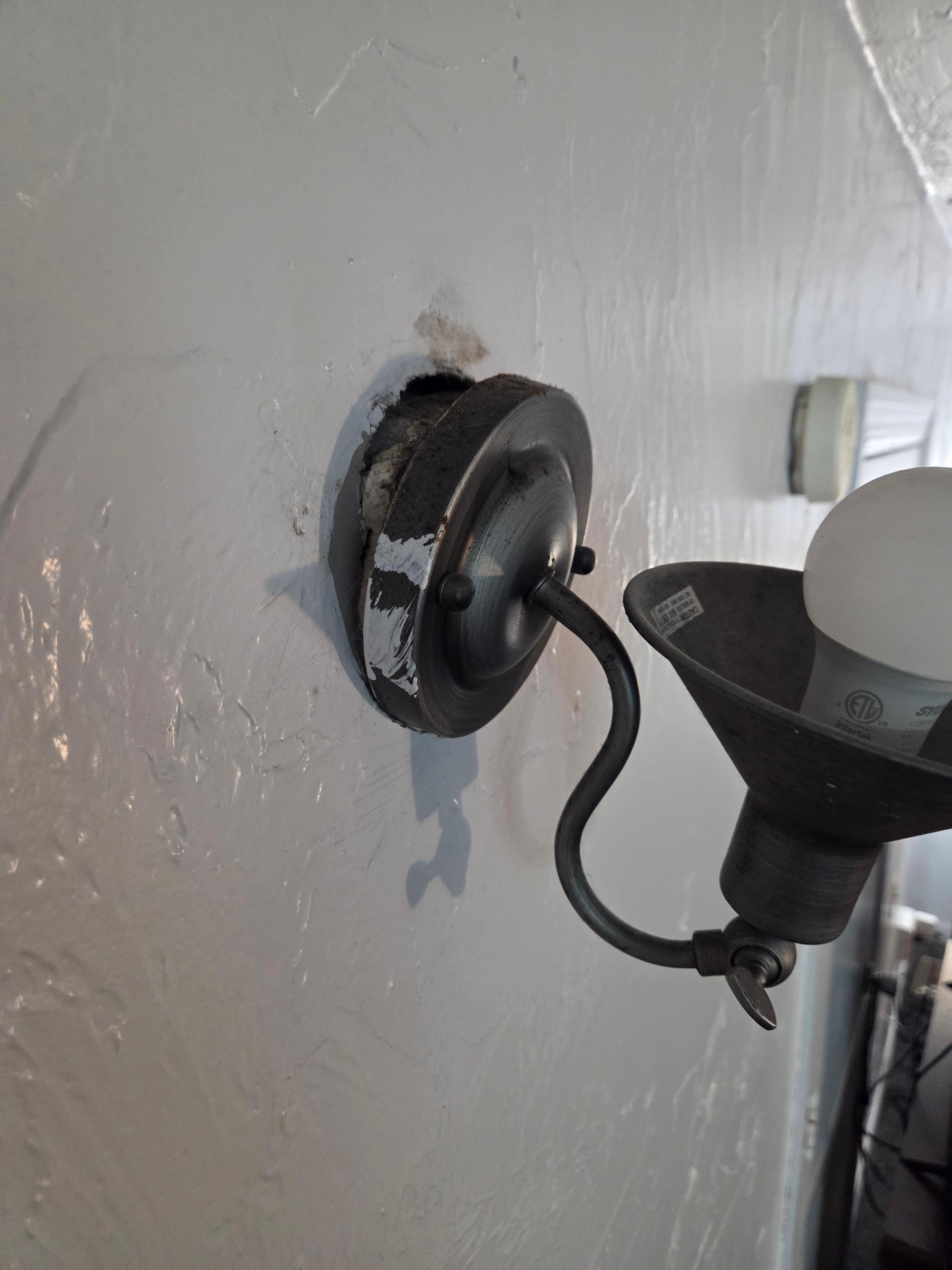 light out of service and hanging out from wall