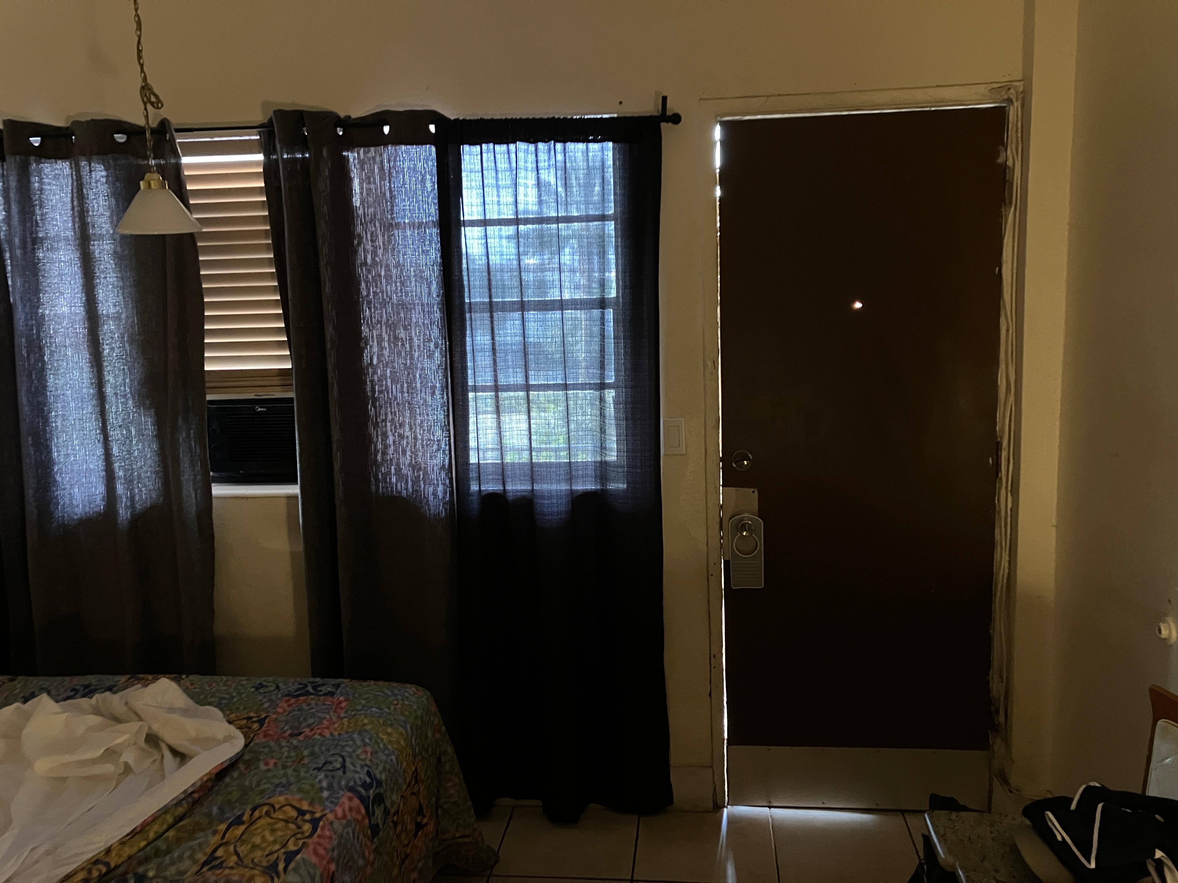 Widow was cracked, door gap was huge, curtain didn’t keep out any light.  