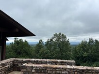Trees and mountain ridges at front of house