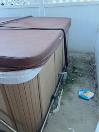 Broken hot tub with garbage