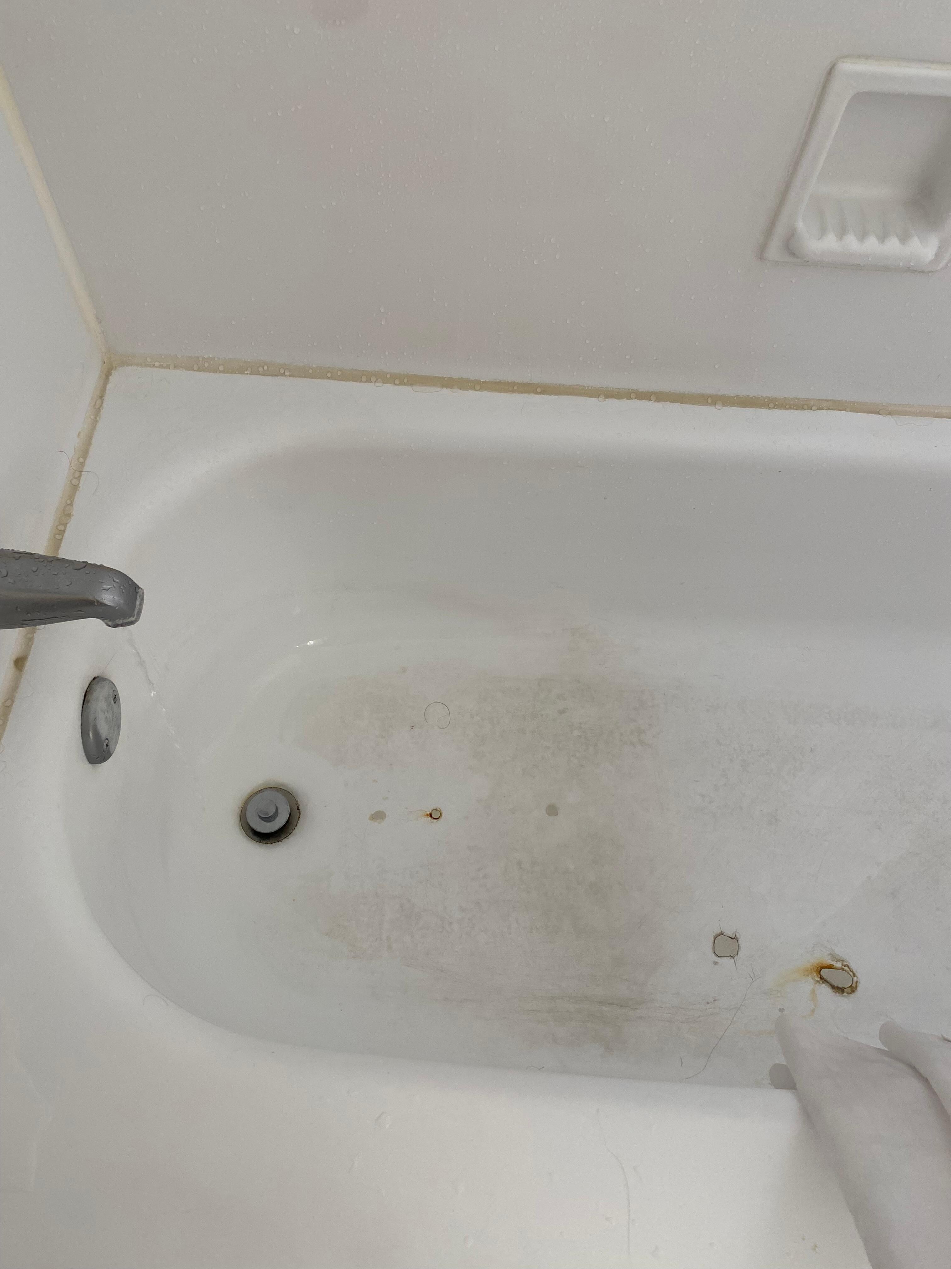 Messed up bathtub floor with leaky faucet