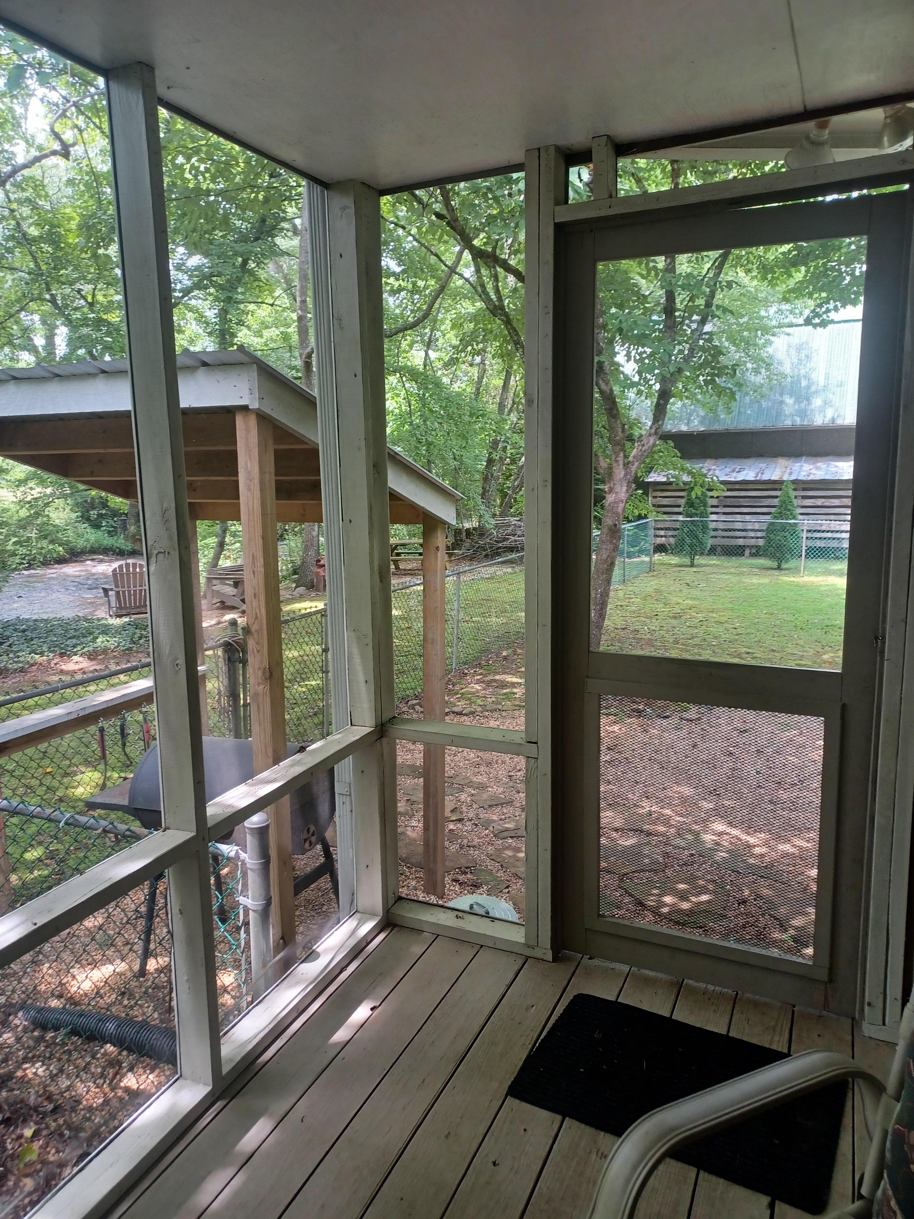 Door from screened porch to fenced in dog yard, bbq.