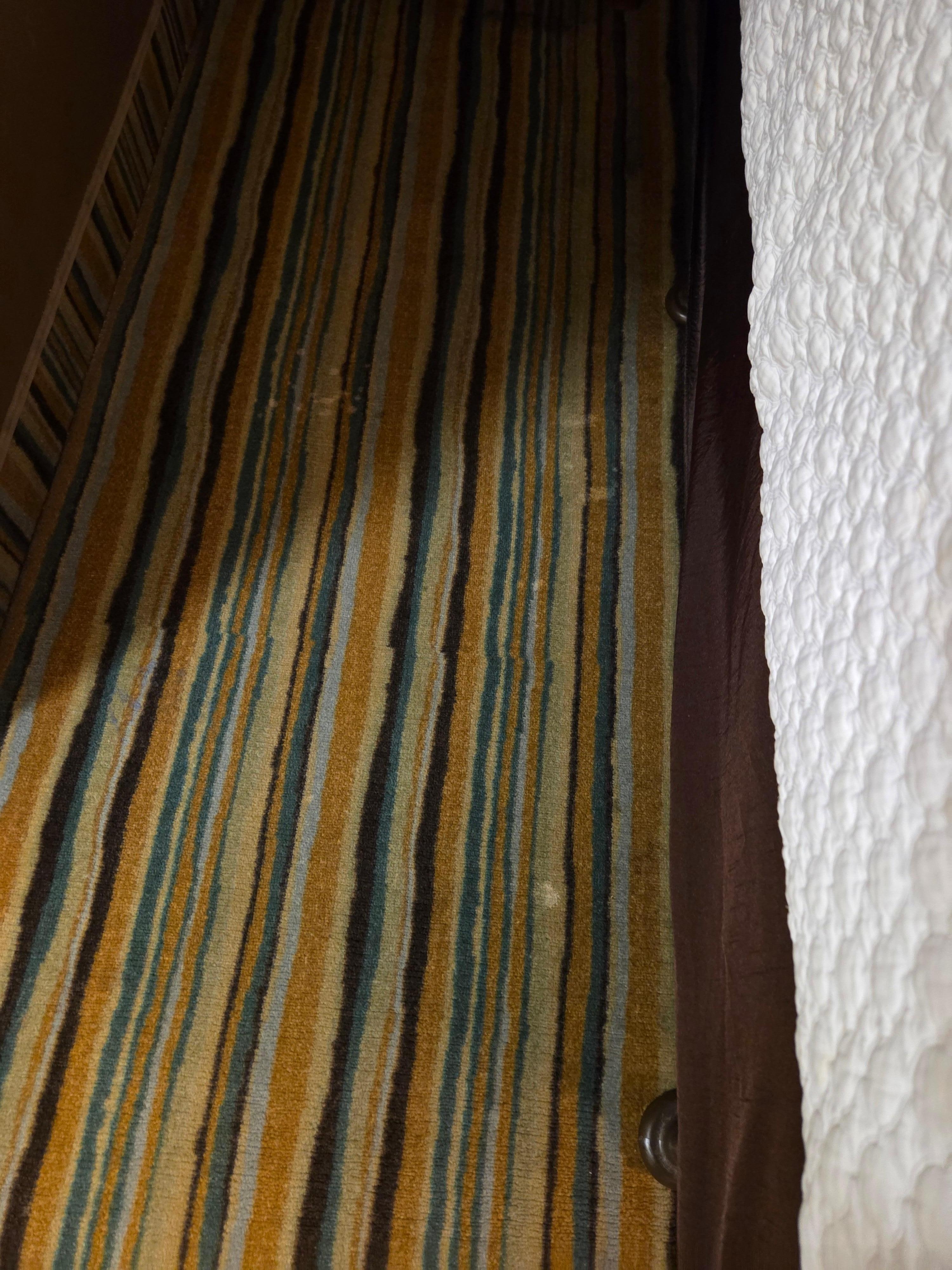 White stains on floor by bed 