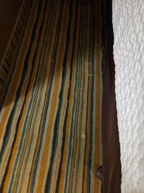 White stains on floor by bed