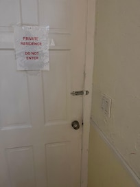 Weird door to first floor tenant. Opens straight into our hallway.