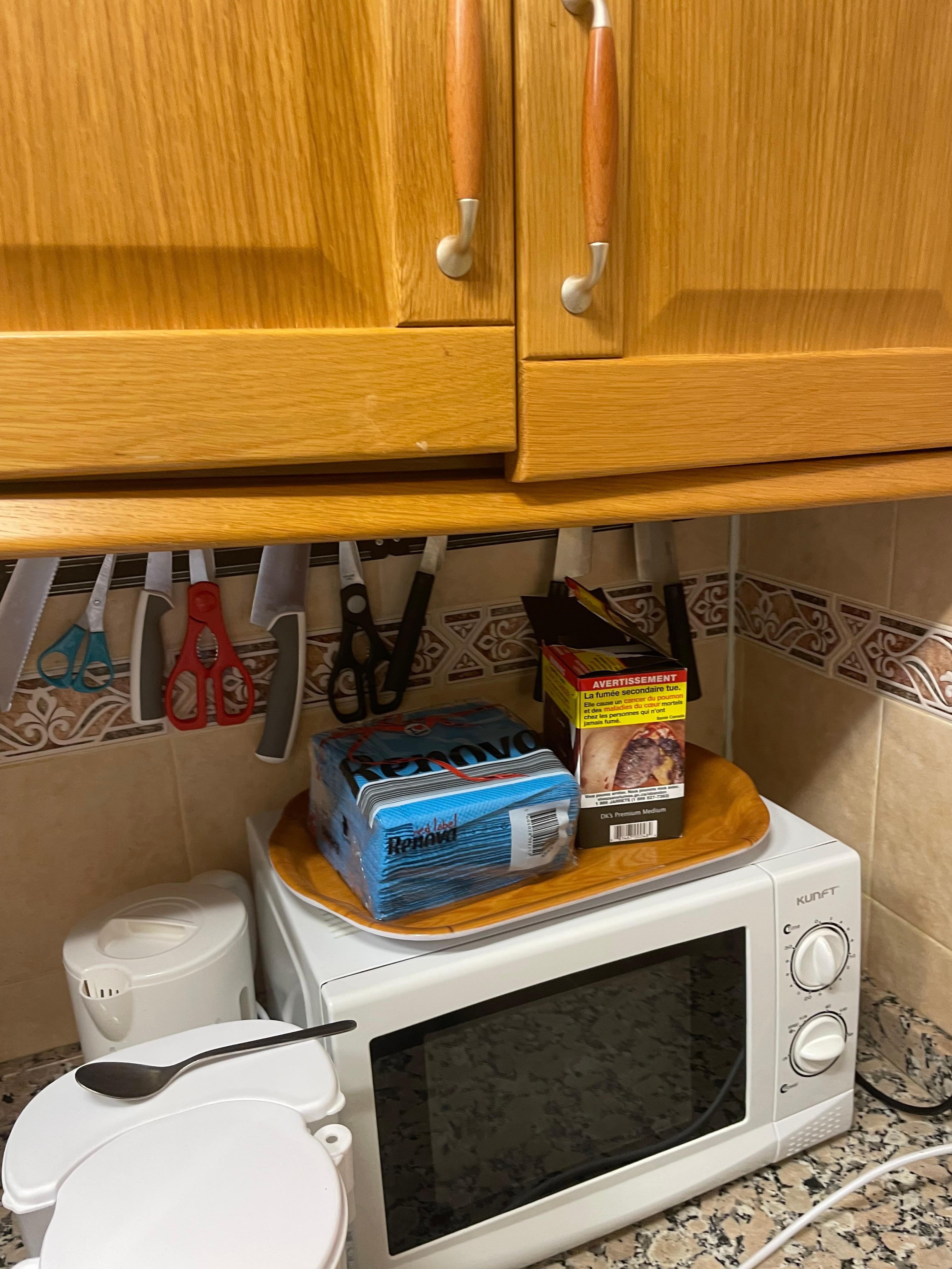 Broken cabinet hanging off the wall