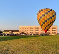 A hot air balloon landed in front of the hotel.