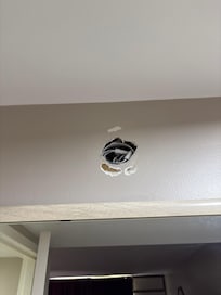 Hole in wall exposing wires
