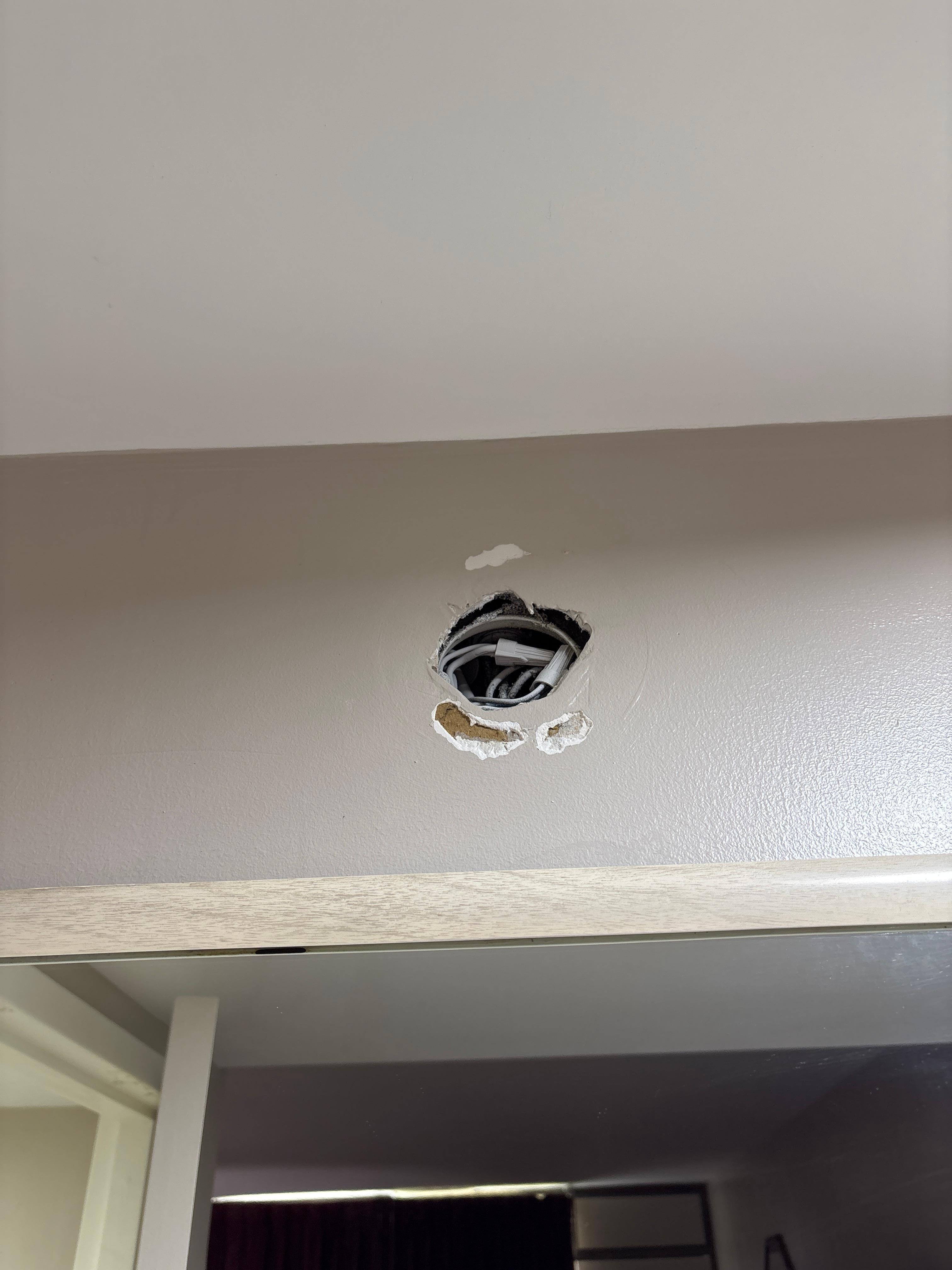 Hole in wall exposing wires