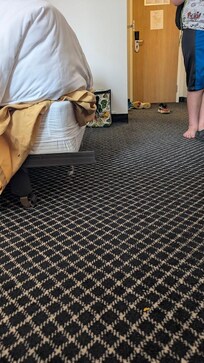 The bed frame overhands by about 2 inches on one side on the best closest to bathroom. This it the only edge that had overhang between the 2 beds