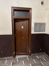 The the circuit board at the street entrance is hidden behind this door