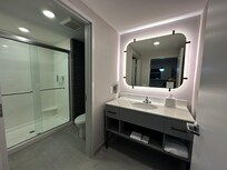 Bathroom with separate doors for shower/toilet and sink/mirror