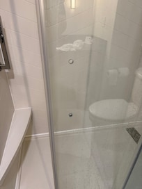 The shower door with missing door handle