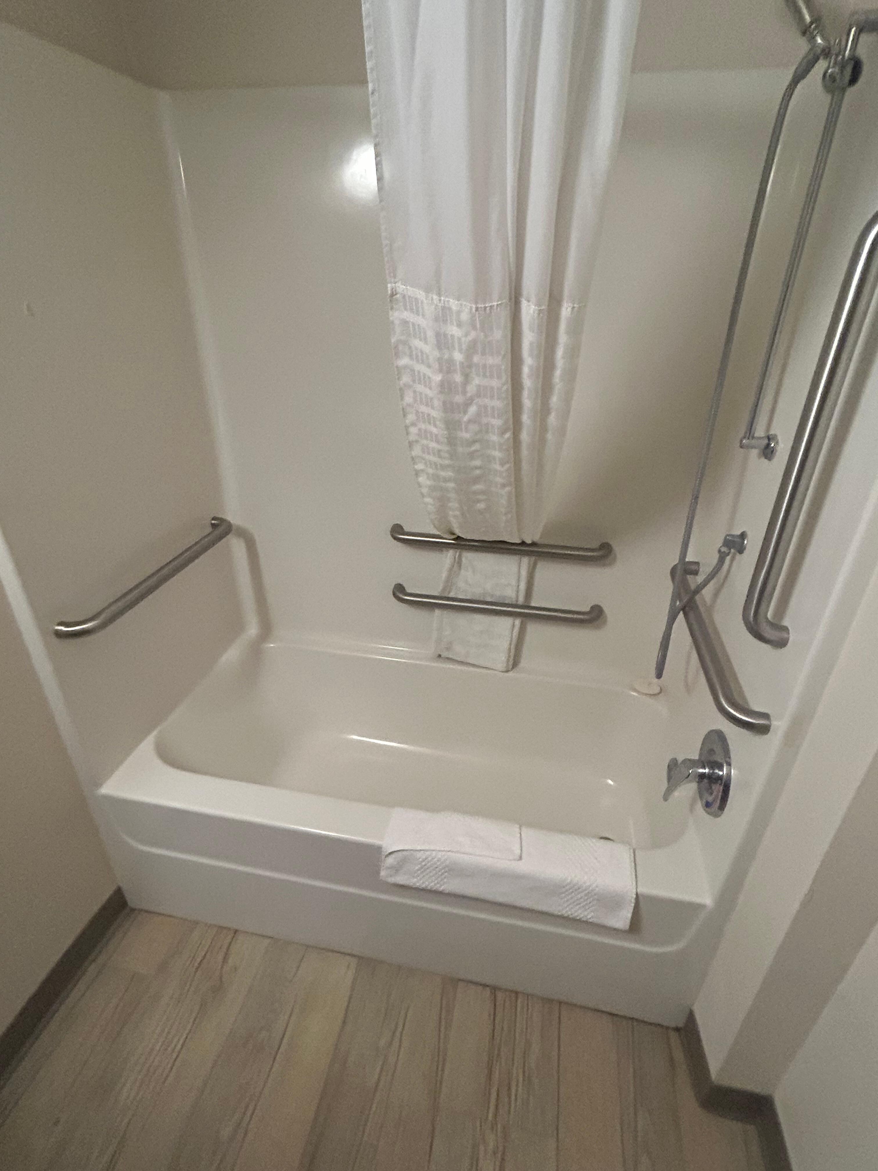 That’s NOT a roll in shower and it has no chair or bench. 