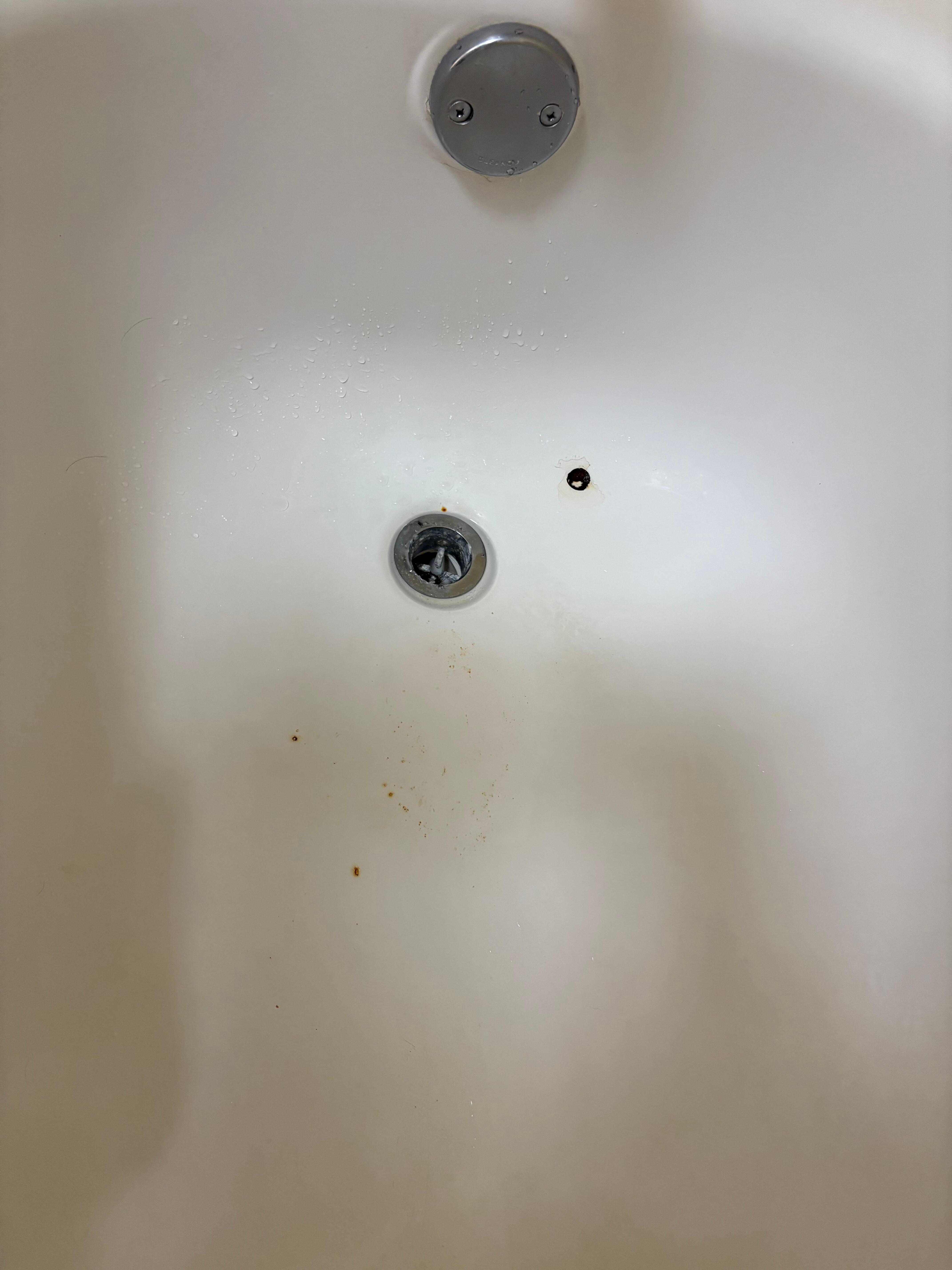 Bathtub with rusty holes and no stopper