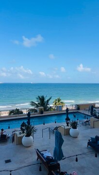 View overlooking the pool from the room balcony & the ocean beyond!