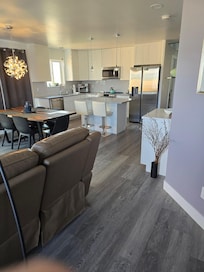 The kitchen, dining area and part of the reclining on either end couch. Comfortable!