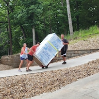 Kids helping Caretaker with the new refrigerator