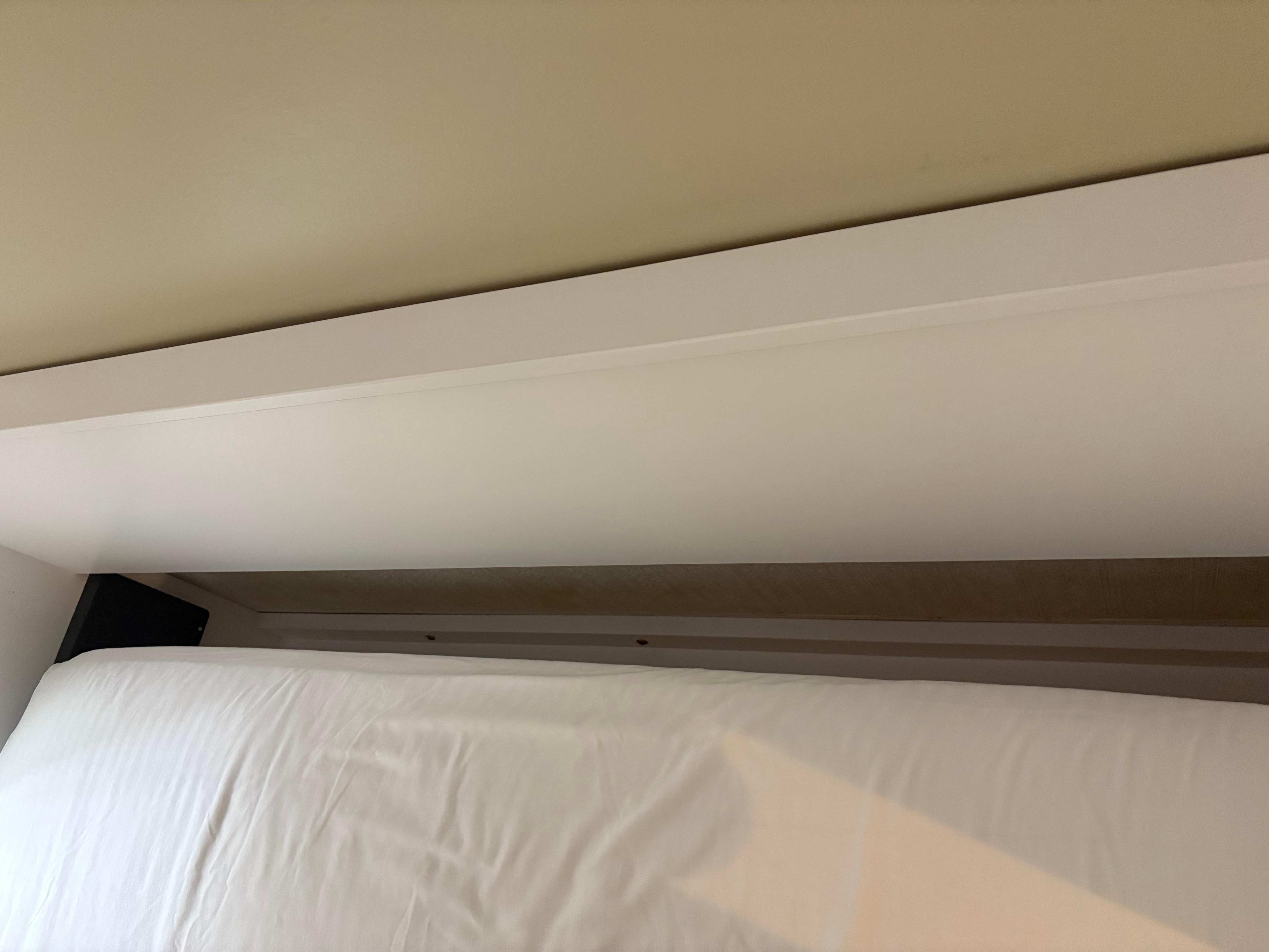 Significant gap between mattress and headboard.