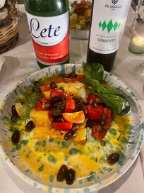 The truly delicious cod plate with olives and tomatoes