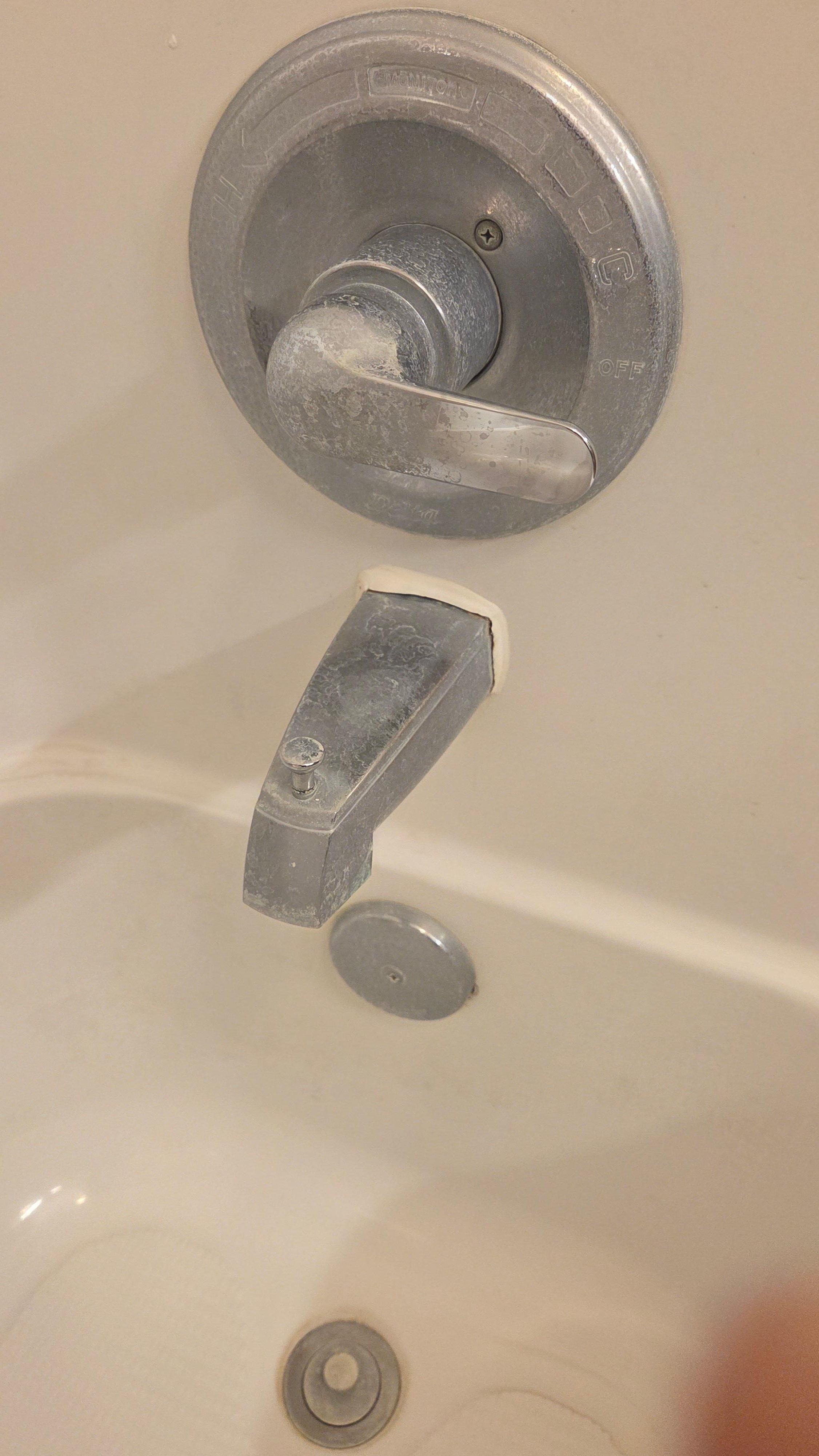 scum on bathtub handles and ring around the tub