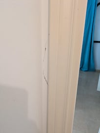 crack on wall by door