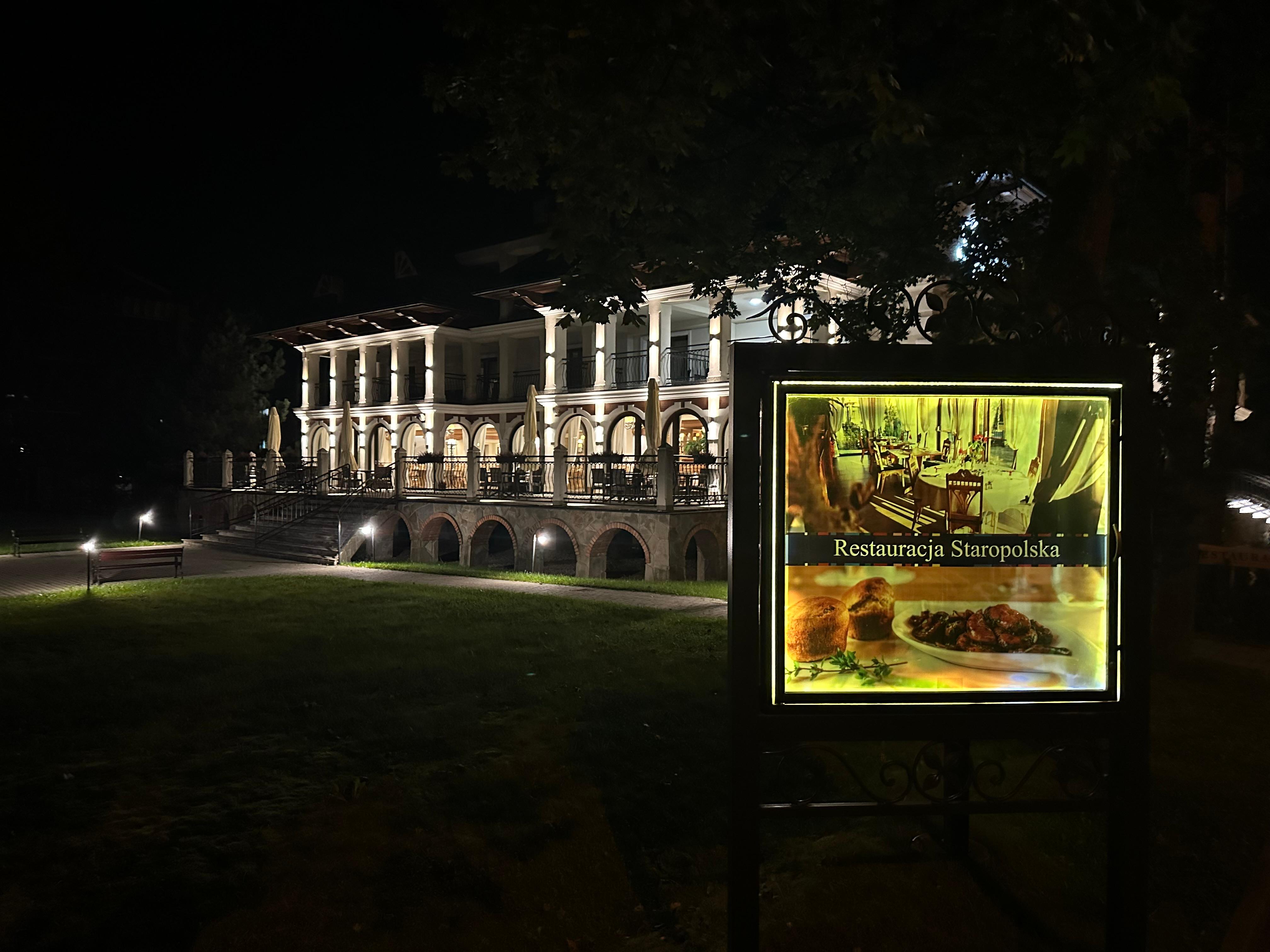 Restaurant sign in front of hotel. 