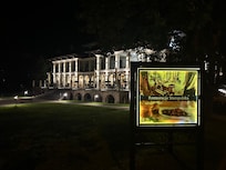 Restaurant sign in front of hotel.