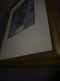 Broken frame above bed