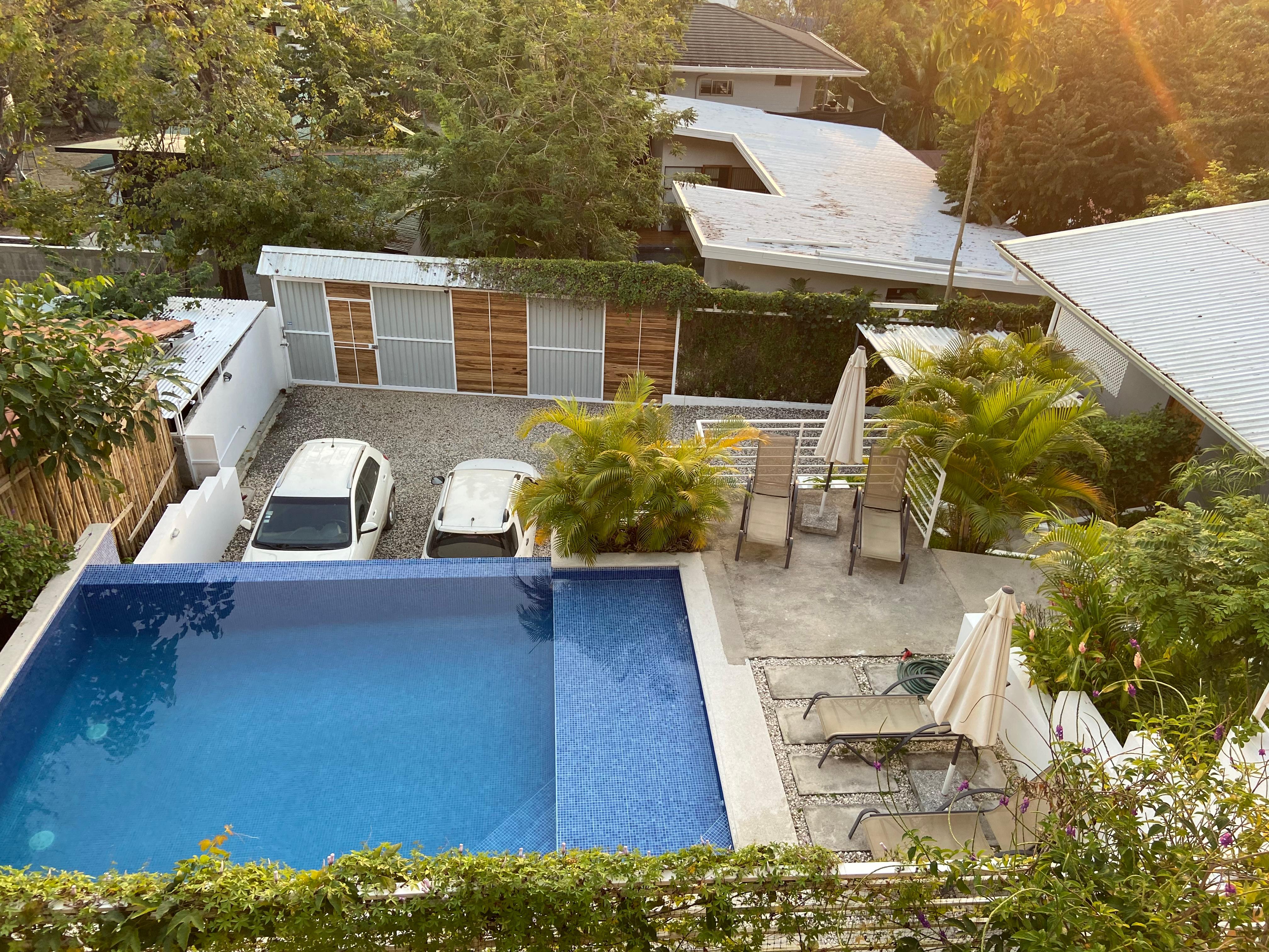 Pool with secure parking area behind.