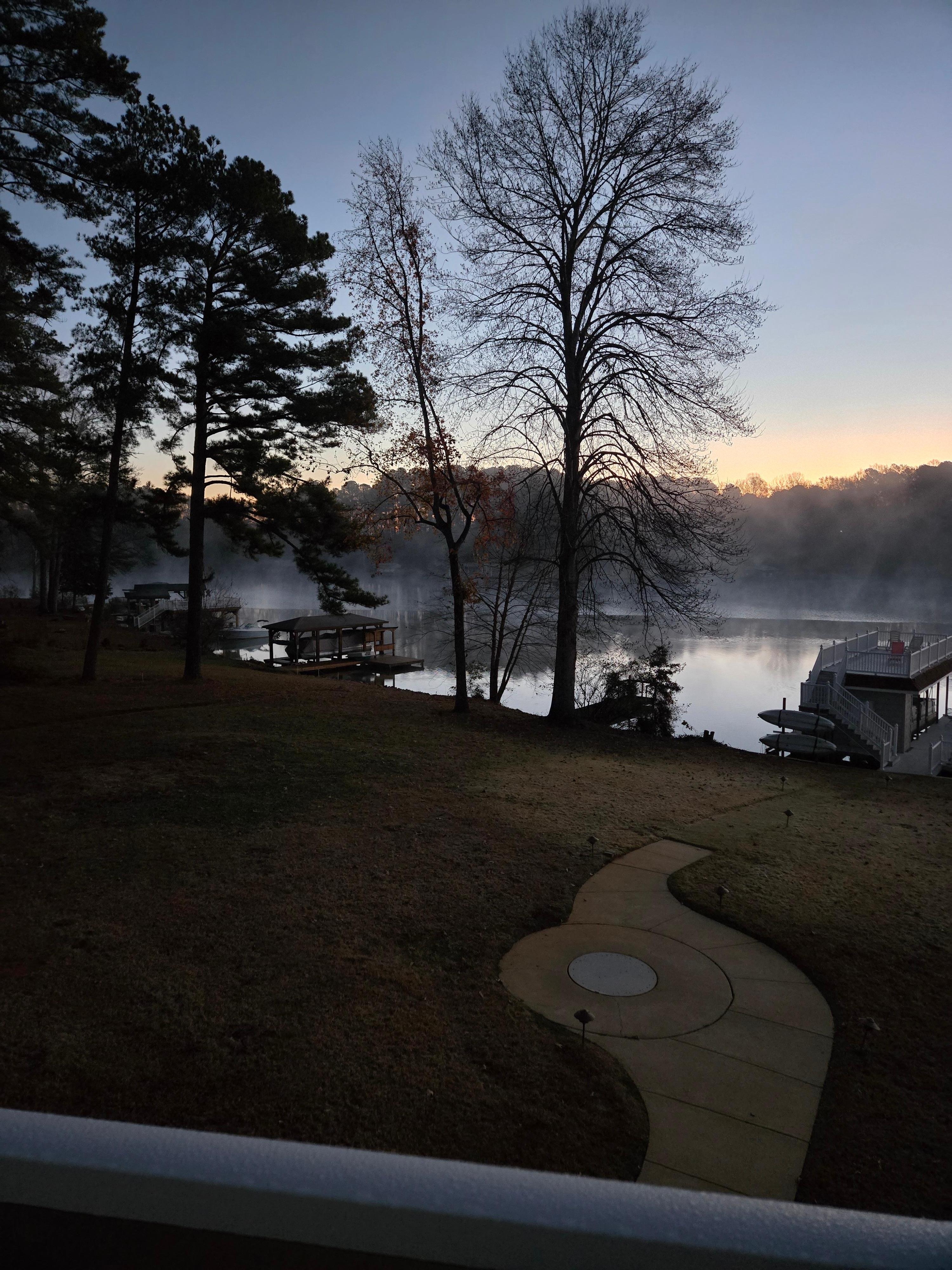 Rear yard with firepit & view to lake from deck