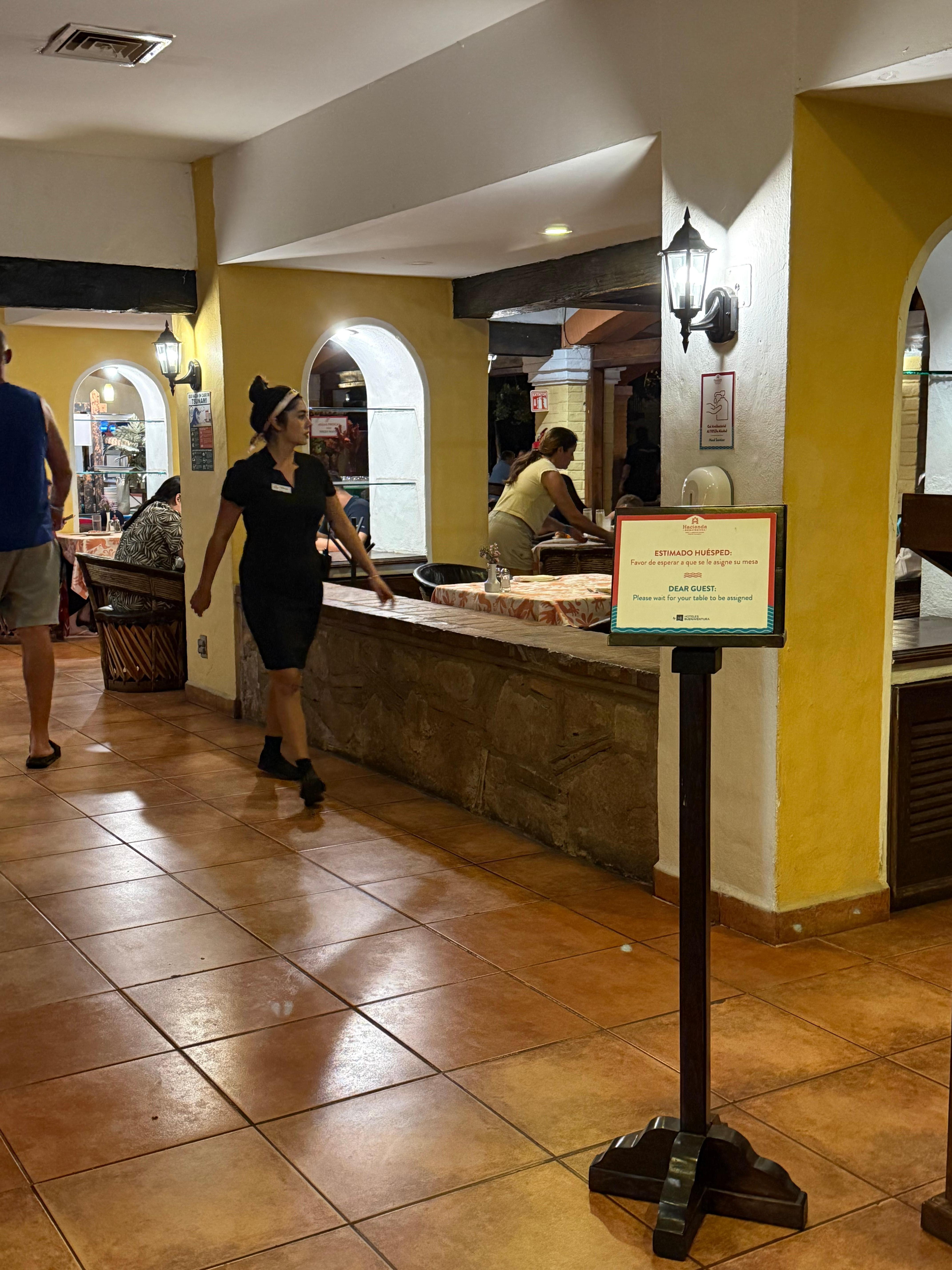 The table next to the wall is where we sat. The wall is where people sat while waiting for a table.