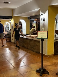 The table next to the wall is where we sat. The wall is where people sat while waiting for a table.