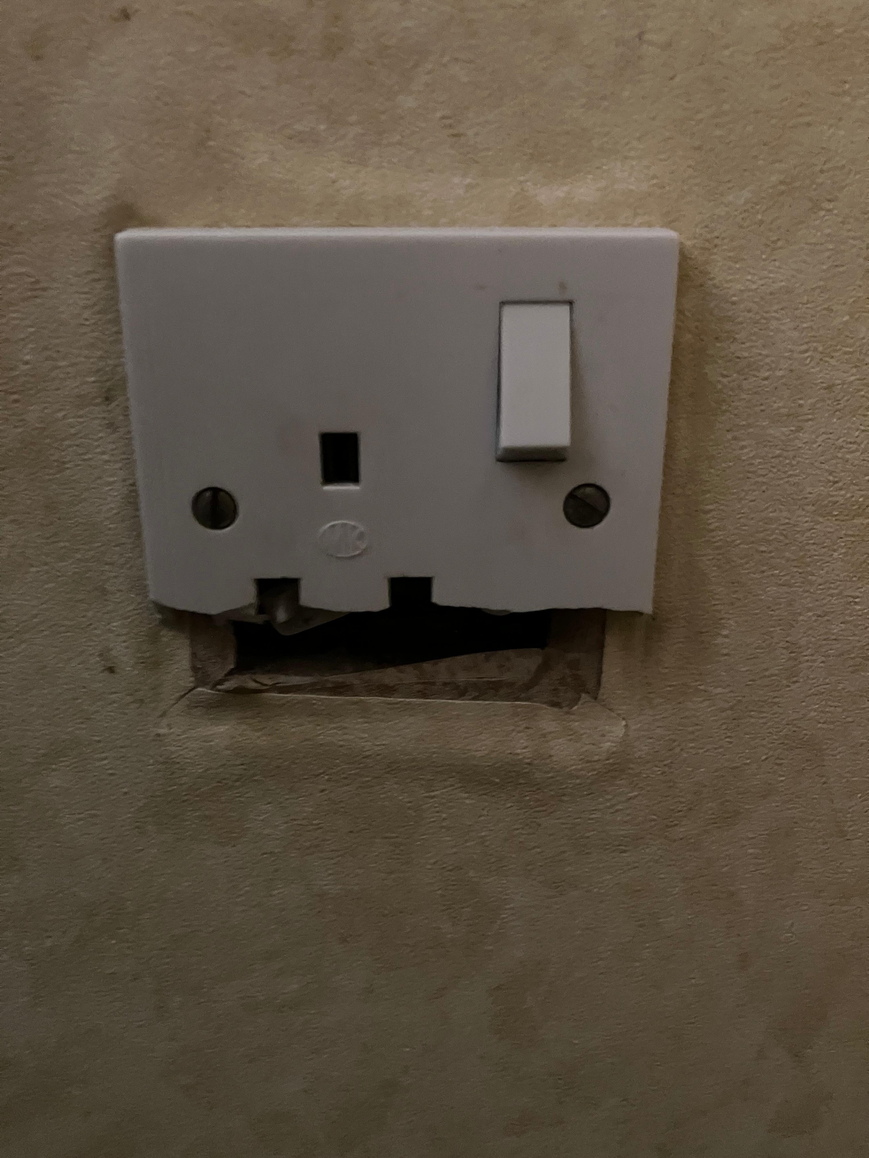 Unsafe plug socket - potential source of electrocution. 