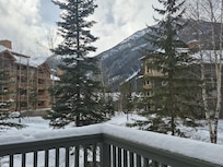 Deck has table and grill. Hot pool/tub across road past bldg on left.