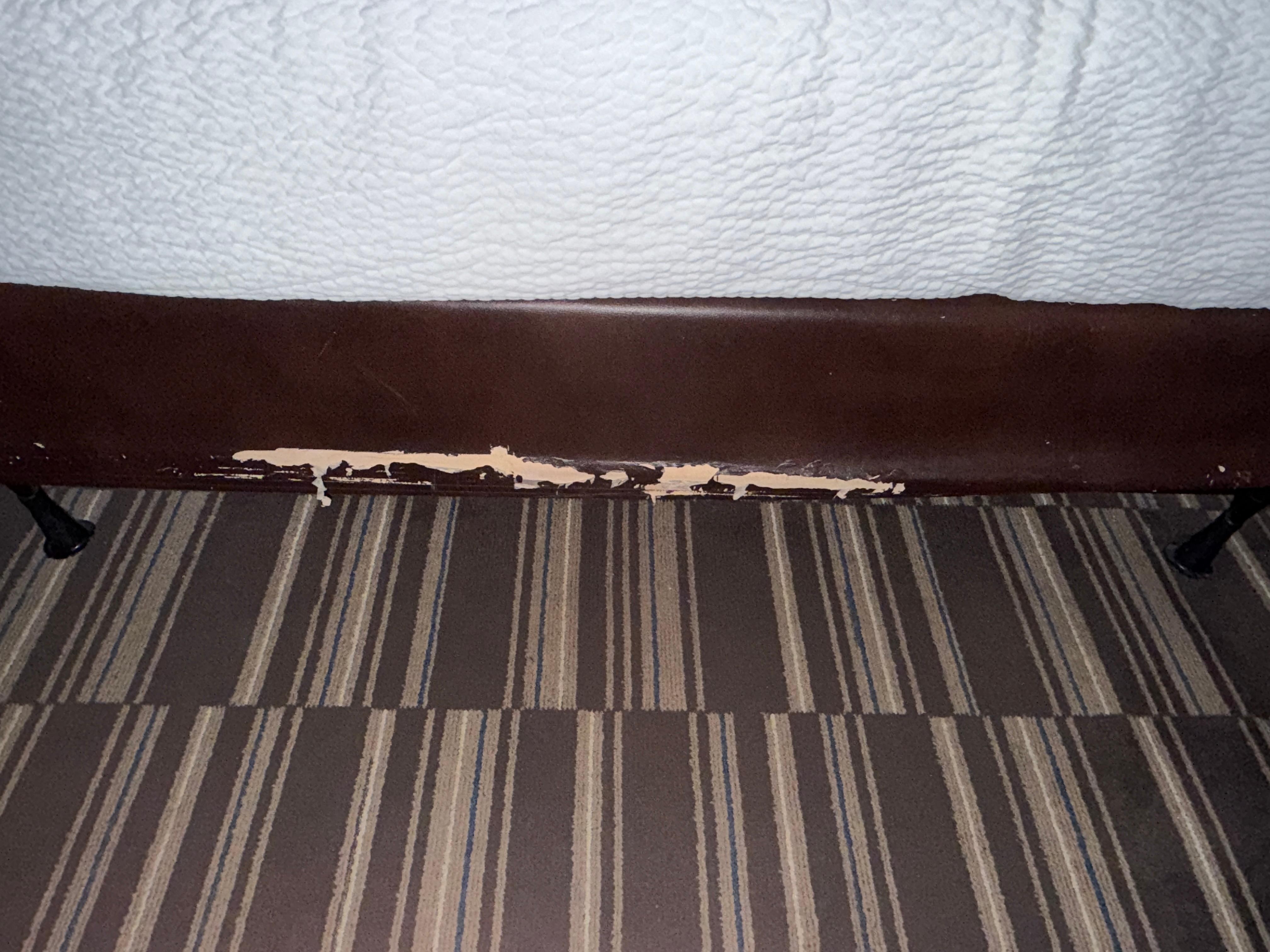Ripped upholstery on bed